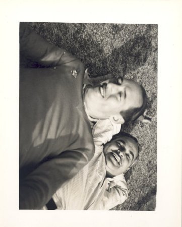 two men laying on grass