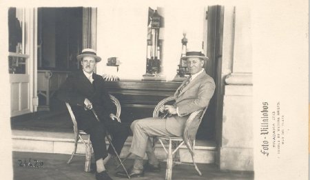 men sitting outside at table