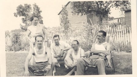 four men sitting with one lady